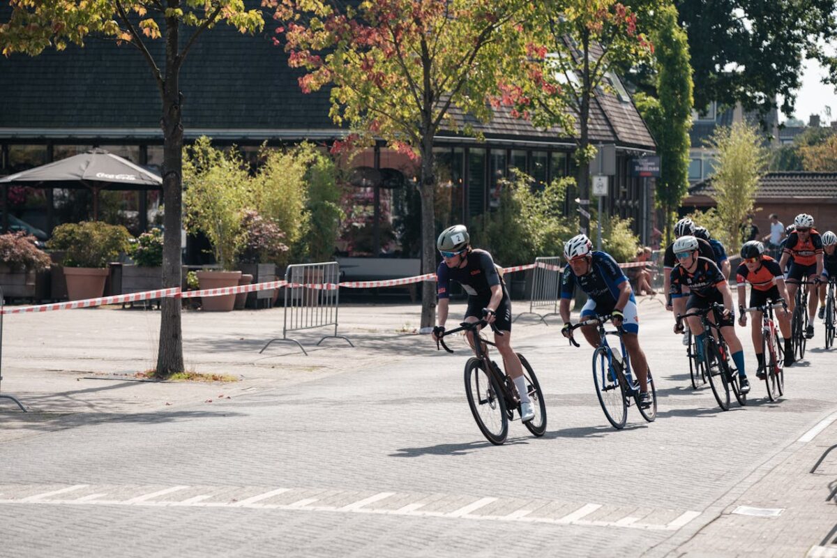 Exciting urban cycling race with athletes in competitive gear speeding through a city street.